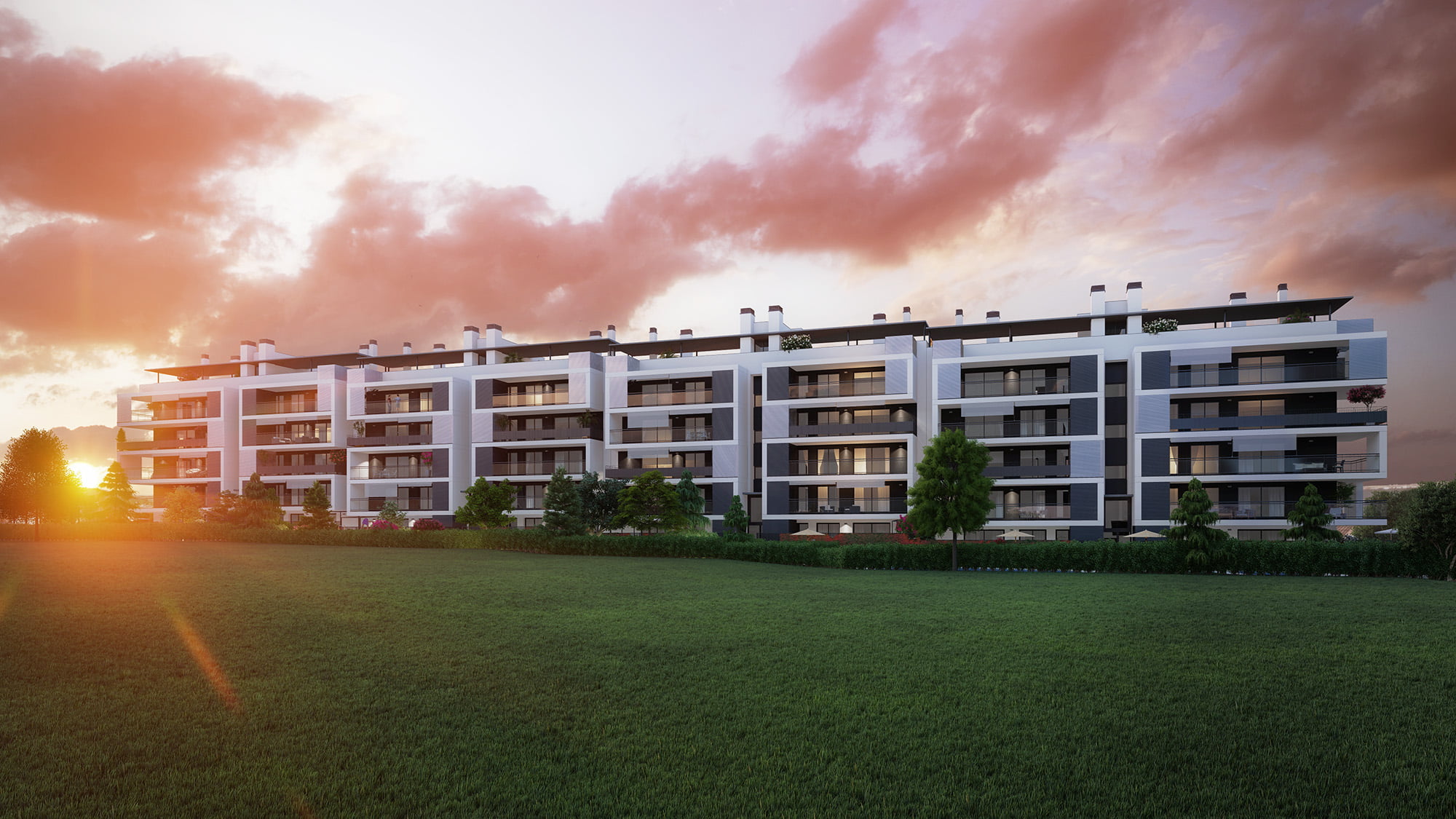 Render al atardecer del edificio de viviendas en Cuarte de Huerva con cielo anaranjado y pradera verde