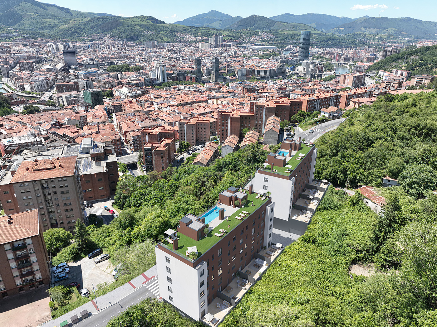 Vista aérea del residencial de Vía Lezama en Bilbao con áticos con piscina sobre la ciudad y la ría al fondo